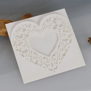 Macro view of white laser-cut hollow heart greeting card with detailed lace patterns