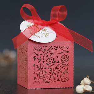 Detail of red laser-cut gift box with floral patterns, ribbon, and Thank You tag