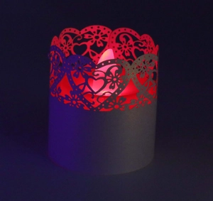 Detailed laser-cut heart pattern on LED candle paper shade with red glowing light