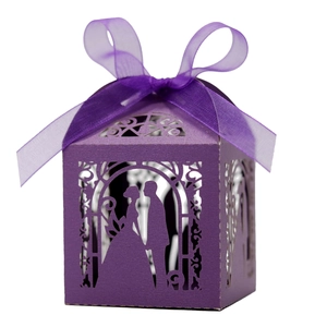 Laser-cut purple wedding favor box with ribbon bow and elegant couple silhouette