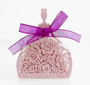Close-up of glittery pink princess dress favor box with hollow floral patterns and purple bow