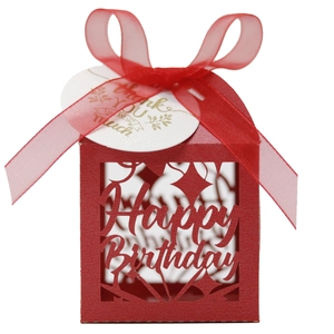 Detail of red hollow laser-cut Happy Birthday gift box with silk ribbon and thank you tag