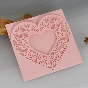 Close-up of laser-cut heart greeting card in soft pink pearlescent paper