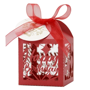 Detail view of red laser-cut candy box with Happy Birthday cutouts and ribbon bow