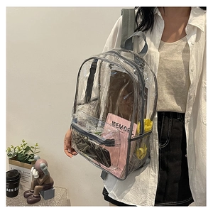 Detail view of transparent PVC backpack with grey fabric trim and side mesh pocket