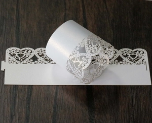 Detail of white laser-cut pearl paper wraps with heart and flower hollow patterns