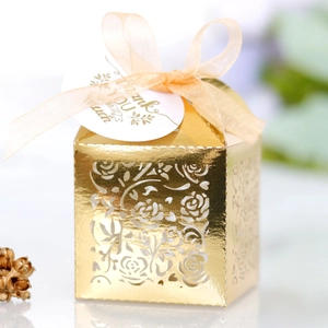 Macro view of gold laser-cut rose gift box with pink ribbon and Thank You tag