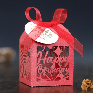Detail of red laser-cut Happy Birthday gift box with silk ribbon and thank you tag