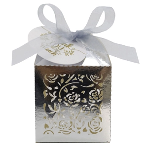 Detail of silver laser-cut rose gift box with blue ribbon and Thank You tag
