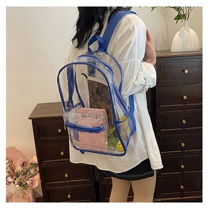 Detail view of transparent PVC backpack with blue trim and adjustable nylon straps
