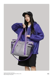 Close-up of waterproof travel bag featuring purple straps and durable side mesh pocket