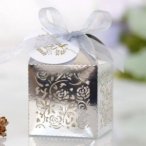 Macro detail of laser-cut rose hollow favor box with ribbon and Thank You tag