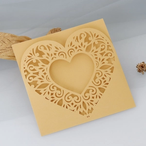 Detailed laser-cut gold heart greeting card with intricate floral patterns for weddings