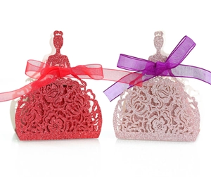 Detail of glitter princess favor boxes with hollow rose patterns and silk ribbons