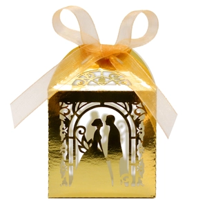 Detailed laser cut gold wedding favor box with bride and groom silhouette and ribbon