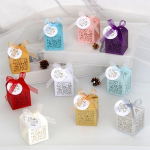 Multiple colors of laser-cut rose gift boxes with ribbons and thank you tags