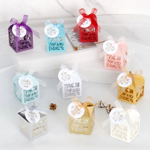 Detail of laser-cut Happy Birthday gift boxes with ribbons and Thank You tags