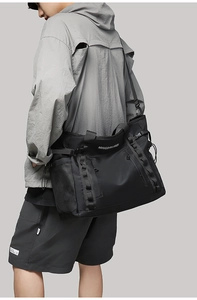 Detail of waterproof nylon shoulder bag with side mesh pocket and buckle straps