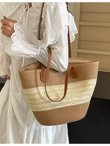 Large straw tote bag with brown leather straps and striped contrast weave design