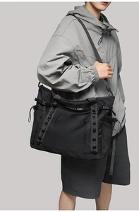 Black tactical travel bag with multi-compartment design and durable webbing system