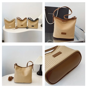 Detailed view of woven straw bucket bag showing leather base and reinforced handles