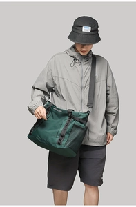 Macro detail of waterproof nylon travel bag in dark green with mesh side pocket