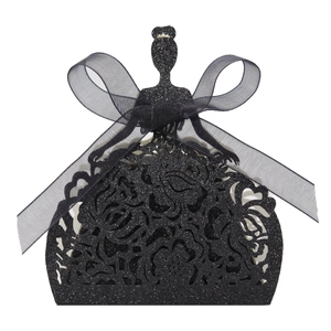 Macro view of laser-cut black glitter favor box featuring elegant gown silhouette