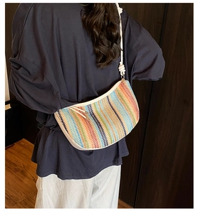 Detail of colorful woven shoulder bag with rainbow stripes and thick rope strap