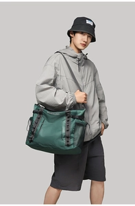 Detail of dark green waterproof sports bag featuring adjustable buckle and side mesh pocket