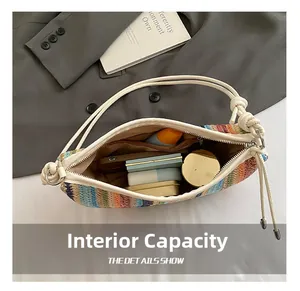 Detail showing inner capacity of rainbow woven shoulder bag with daily essentials inside