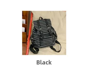 Detail view of black striped canvas backpack with flap closure and twin buckle straps