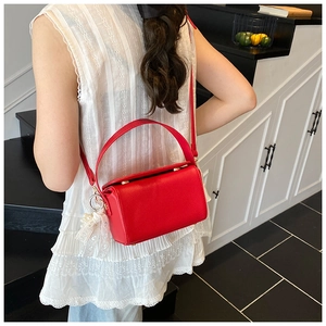 Red small square bag with litchi texture leather and white lace pearl pendant detail