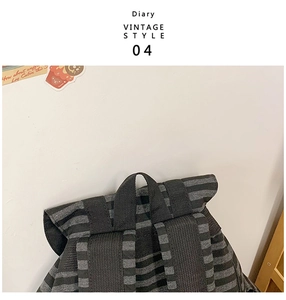 Detailed view of the vintage striped backpack showing reinforced straps and sturdy handle