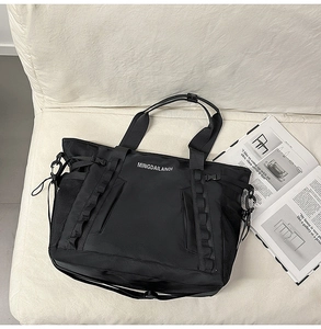Detail of waterproof nylon travel bag featuring tactical straps and side mesh pocket