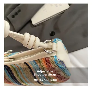 Detailed close-up of woven shoulder bag featuring white leather trim and silver ring