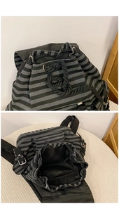 Detail of grey striped backpack showing drawstring closure and spacious interior compartment