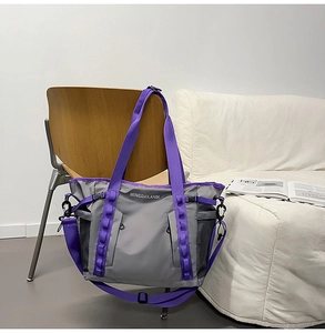 Detail of grey and purple travel bag with durable nylon material and side mesh pocket