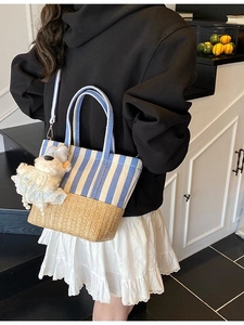 Striped canvas and woven straw tote bag with cute plush puppy charm for summer beach use