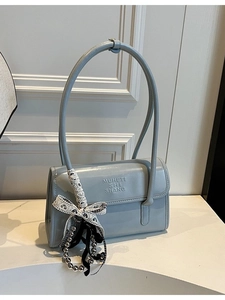 Elegant misty blue shoulder bag with lace bow, chain charms and a long slim strap