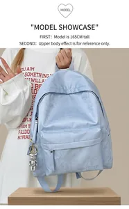 Detail of light blue floral backpack with silver bear charm and side pocket storage