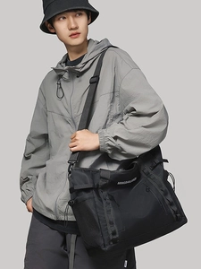 Large black waterproof nylon travel bag with shoulder strap and side mesh pocket for fitness