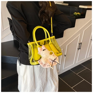 Vue détaillée du sac seau jaune transparent avec pendentif chiot en peluche en situation
