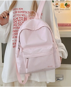 Detailed view of the Hoog letter embroidery on a soft pink lightweight nylon backpack