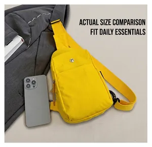 Compact yellow nylon chest bag size comparison with a smartphone on casual clothing
