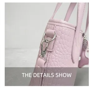 Close-up of silver metal hooks and crocodile pattern on light purple handbag