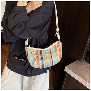 Detail of colorful striped woven shoulder bag with white leather knotted strap design