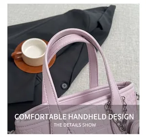 Detail of lavender crocodile embossed handbag with silver chain and dual handles