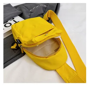 Internal view of yellow nylon crossbody bag with multi-pocket lining and smooth zipper