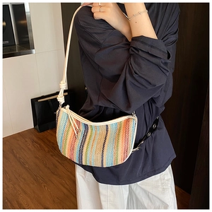 Detailed view of colorful bohemian woven pattern and texture on a crescent shoulder bag