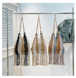 Detail of woven beach tote with bohemian fringes and wooden beads in three colors